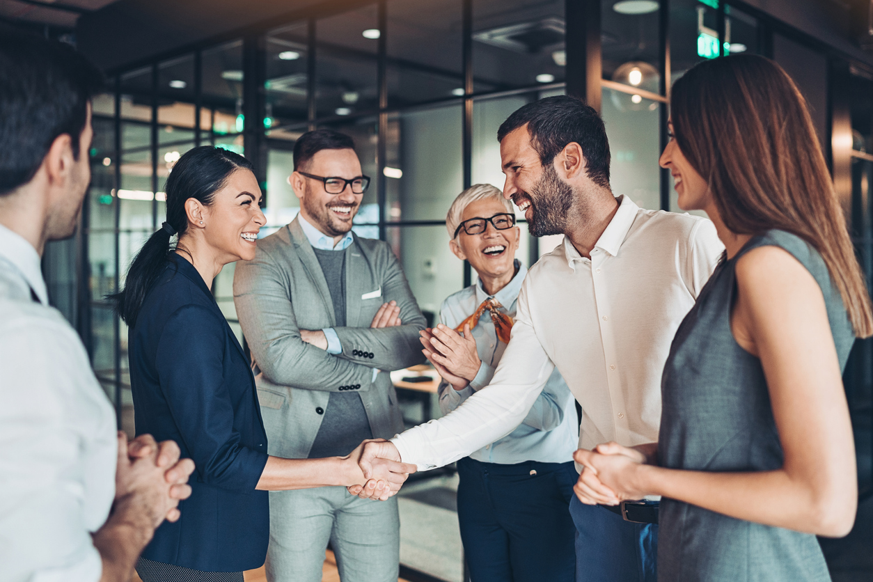 Group of business people shaking hands in an office